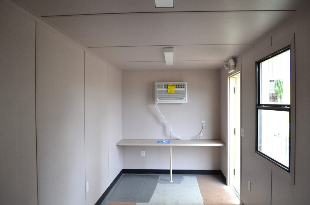 Shipping container interior finishing with HVAC, flooring, and paneling